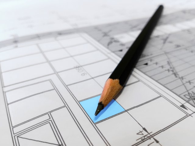 Image of building plans and pencil